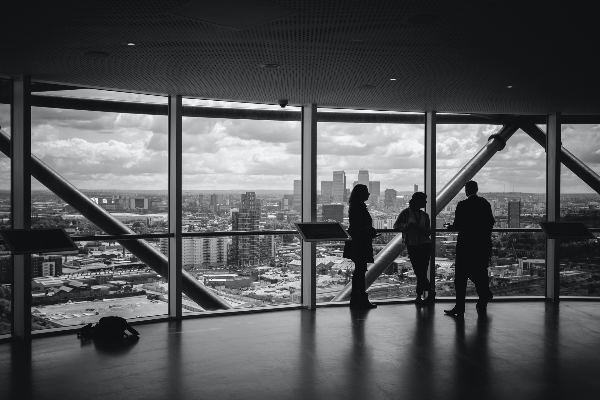 Advisors in conversation overlooking a city skyline